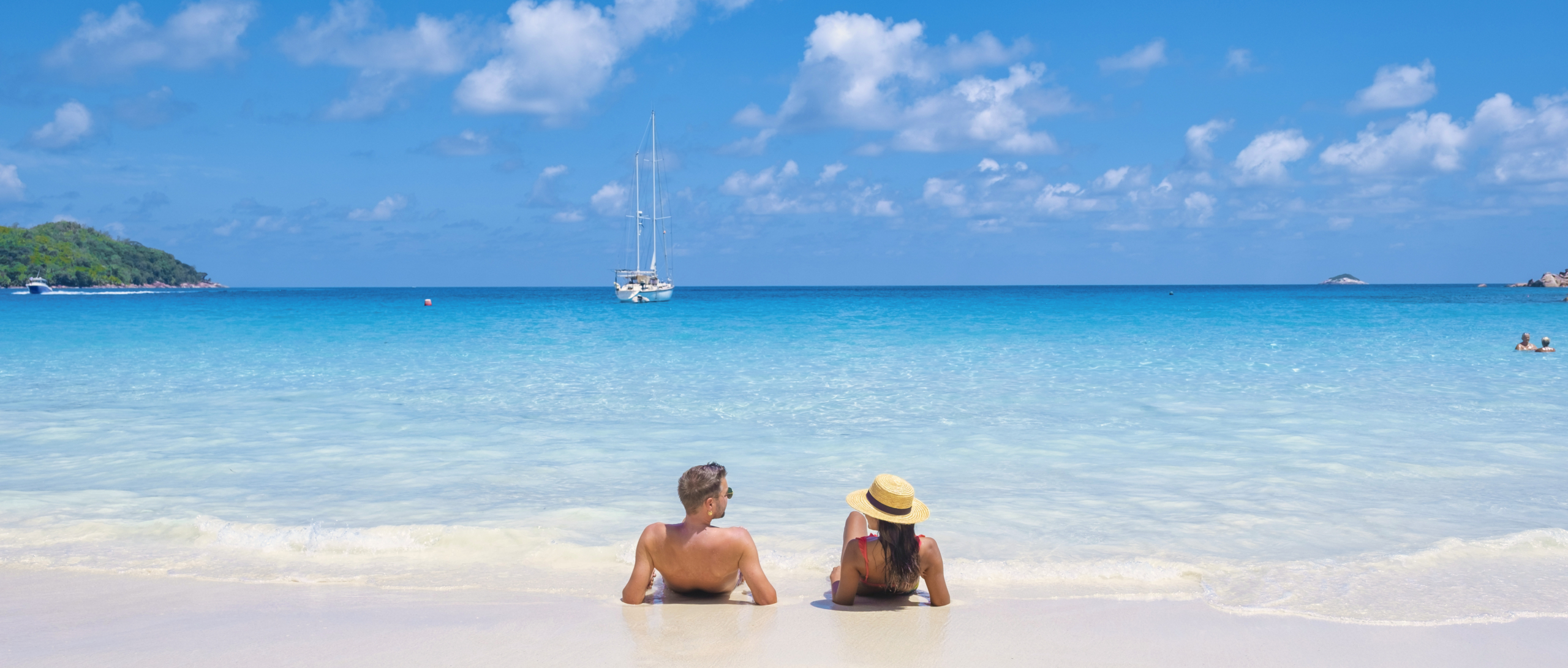 A couple enjoying a quiet beach during off-season travel